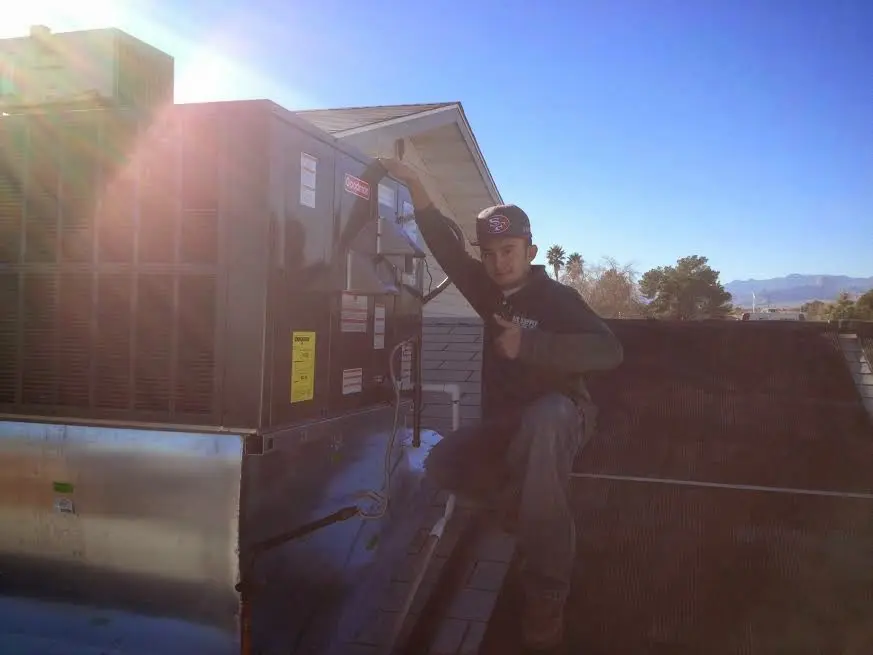 HVAC technician performing HVAC Inspection on a rooftop unit in Fort Thomas